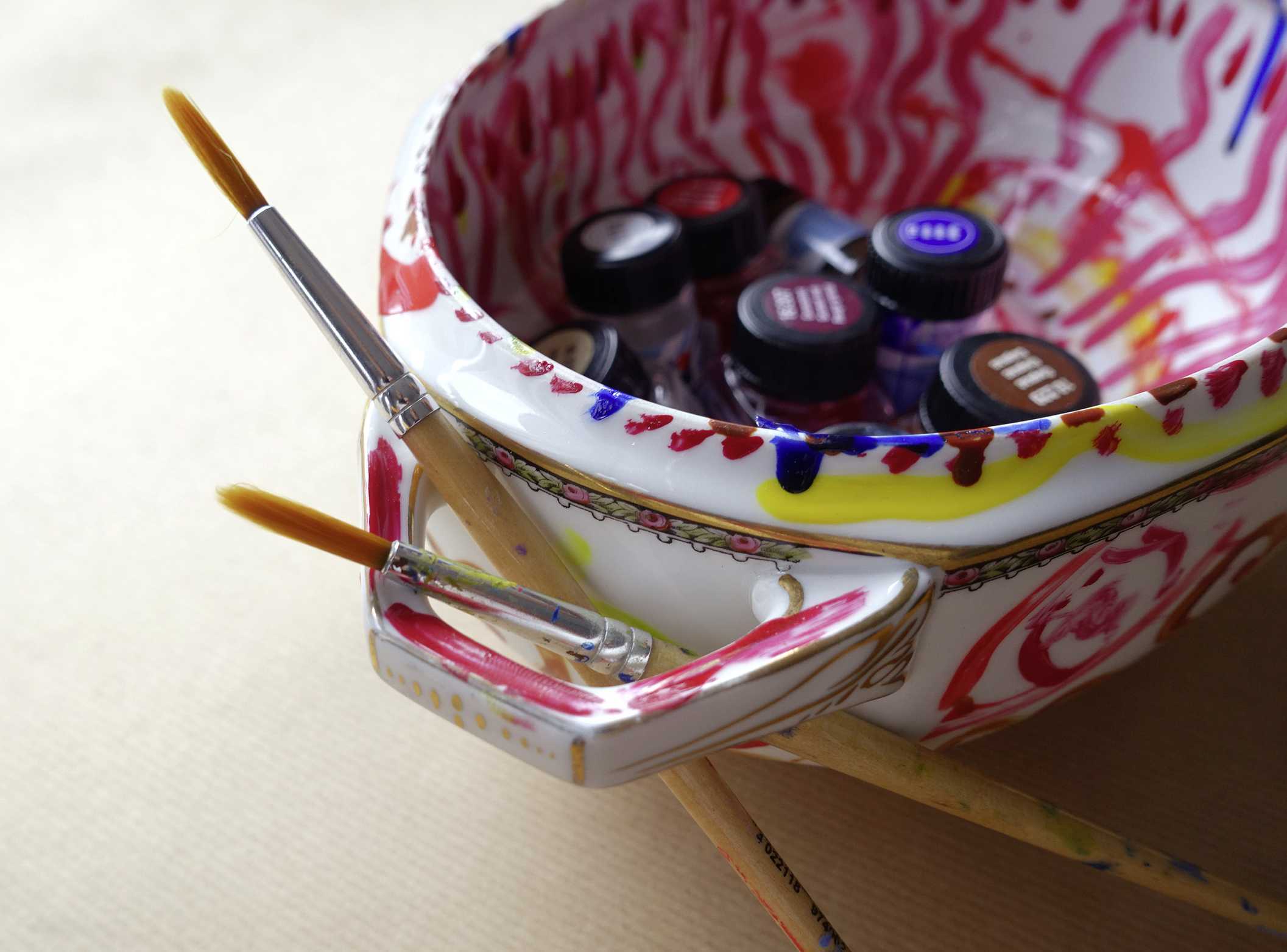 Bemalte Porzellanschüssel mit Pinseln und Farben | Fotoaufnahme von Pirko Schröder